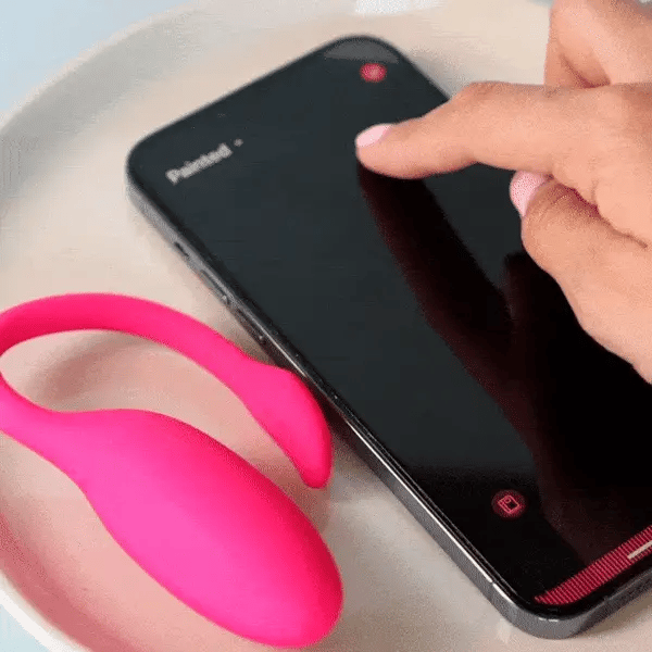 His thumb on the app, the device responding — the mechanism in motion